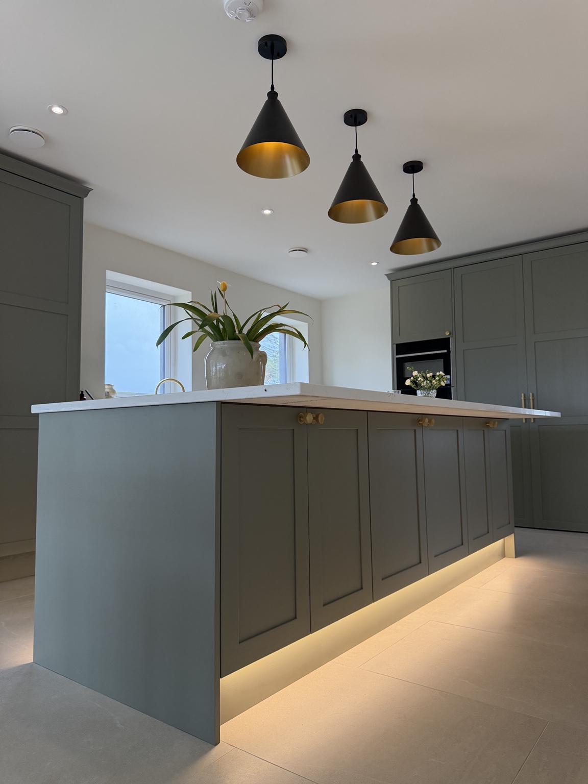 Kitchen island with feature pendant and concealed plinth lighting