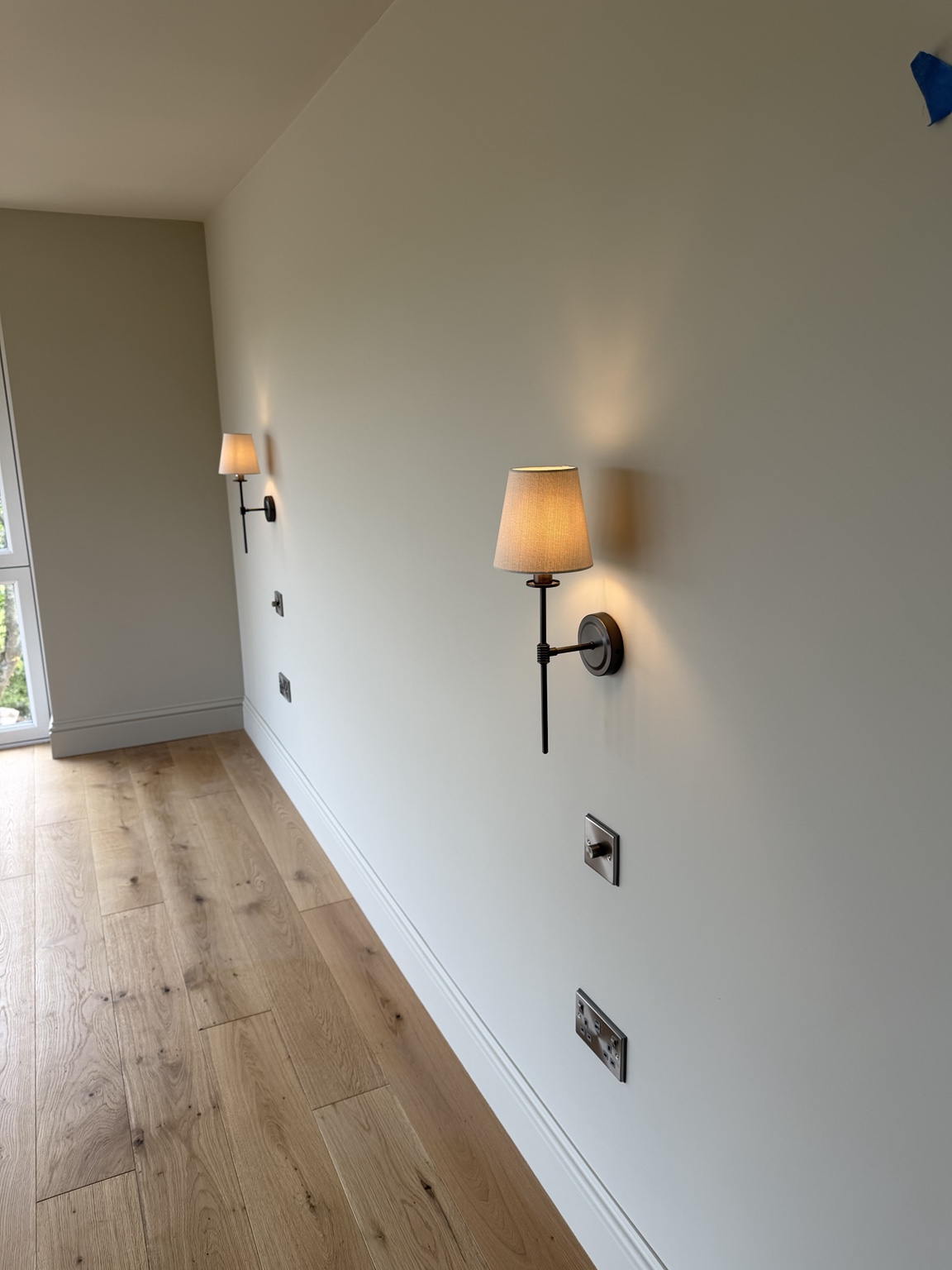 Decorative wall lights and finished sockets in the Cubert home