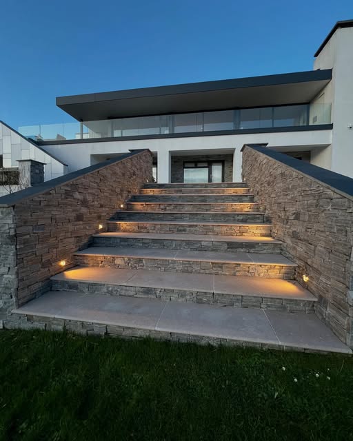 Recessed lights illuminating stone exterior steps